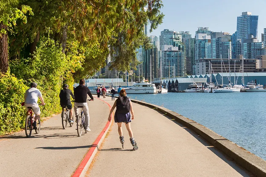 roller blader and bikers in stanley park vancouver.
